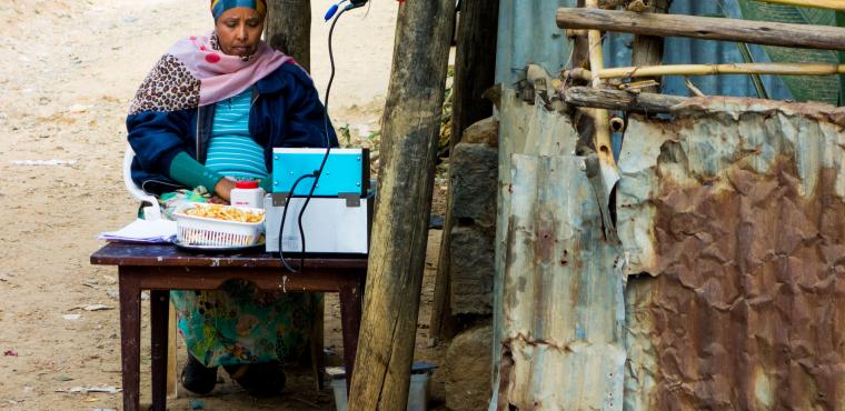 woman cooks french fries by the roadside in Addis Ababa, Ethiopia